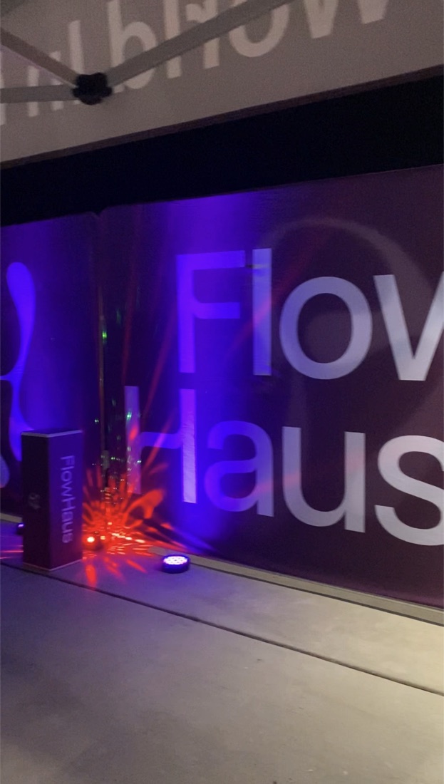 FlowHaus event backdrop lit in purple